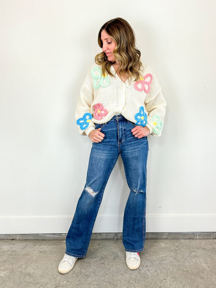 Wearing the Spring Bliss Flower Sweater paired with the Jennifer Judy Blue Jeans.